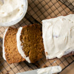 einkorn pumpkin bread sliced with cream cheese frosting